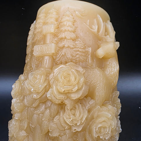 Decorative candle holder with floral design on a dark background