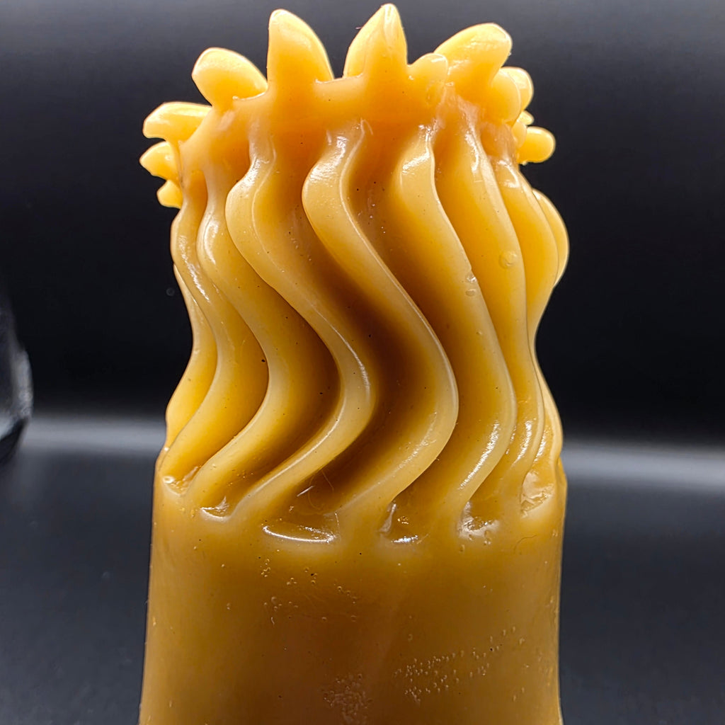 Close-up of a candle on a dark background